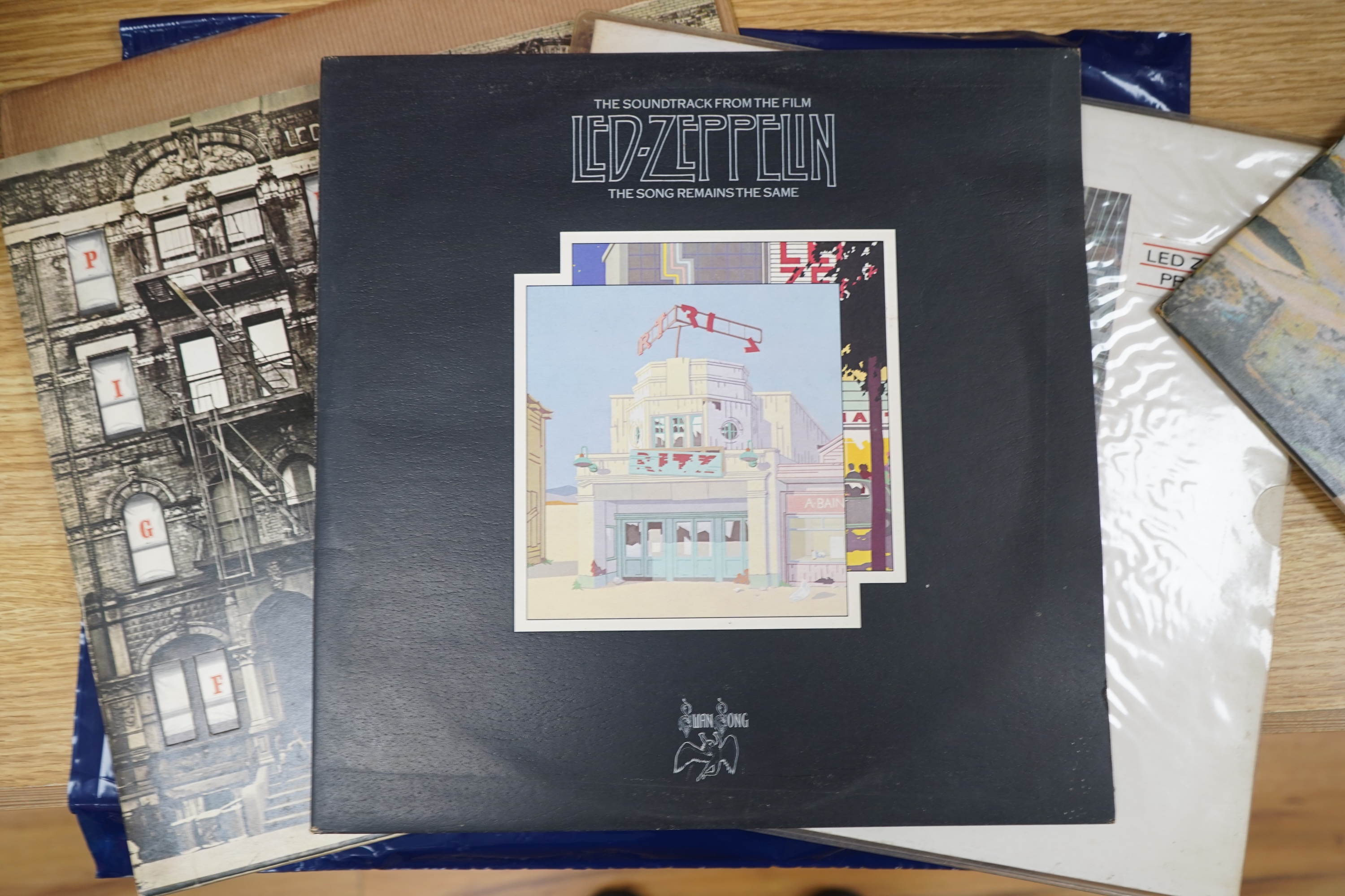 Five Led Zeppelin LP record albums; In Through the Out Door (SSK59410), Physical Graffiti (SSK89400), Presence (SSK59402), Houses of the Holy (K50014), and The Soundtrack from the Film The Song Remains the Same (SSK89402